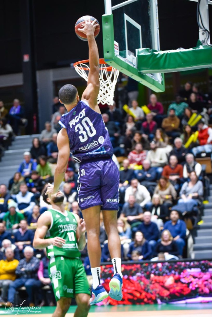 Paul Rigot dunking in a professional basketball game
